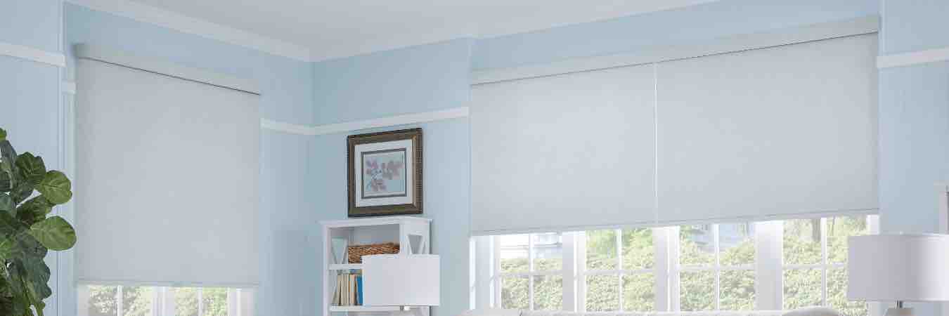 Light gray window shades on windows in a blue family room