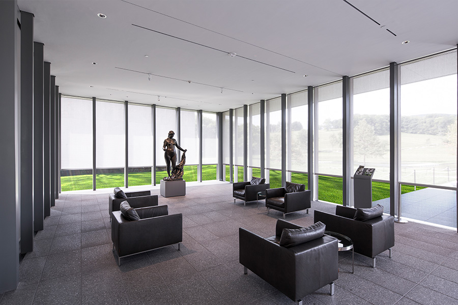 Gray roller shades in a corporate lobby area